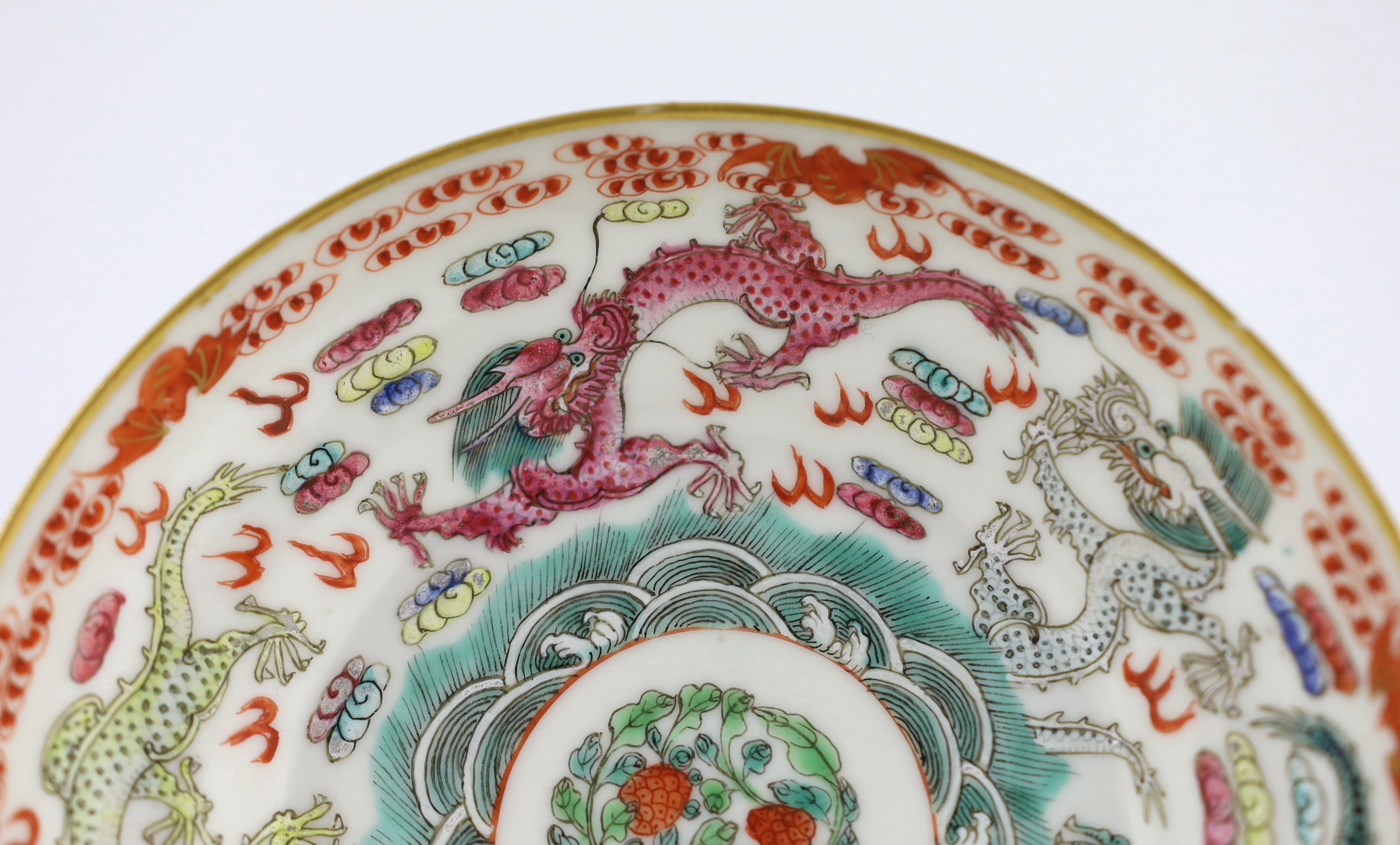 A Chinese famille rose fencai ‘dragon’ saucer dish, Jiaqing four character seal mark, 19th century, 14.6cm diameter